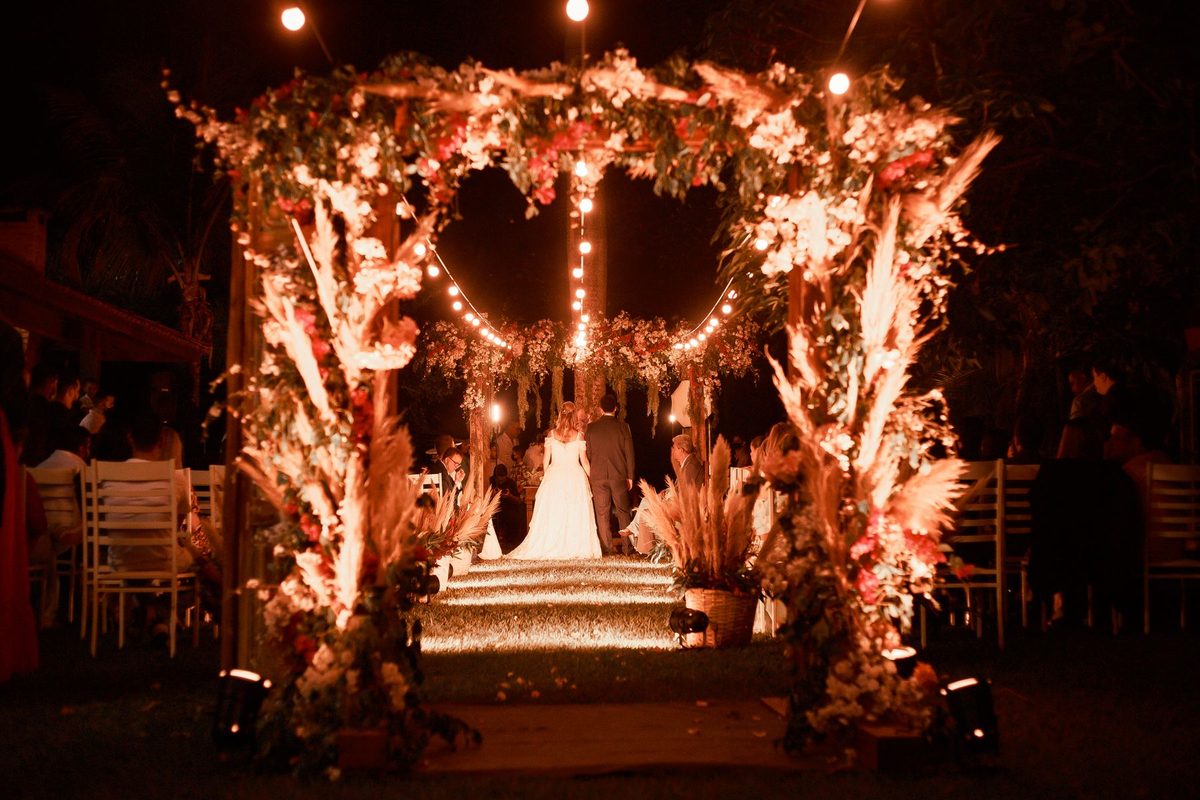 A mandap at night under strings of light